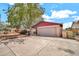 Home exterior featuring an attached garage, mature landscaping, and a concrete driveway at 5140 N 69Th Ave, Glendale, AZ 85303