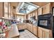 Kitchen featuring white tile floor, vintage cabinets and countertops, and skylight at 5140 N 69Th Ave, Glendale, AZ 85303