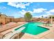 Backyard pool with diving board, pergola, and desert landscaping with blue skies at 5140 N 69Th Ave, Glendale, AZ 85303