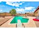 Large in-ground pool in backyard with diving board and desert landscaping at 5140 N 69Th Ave, Glendale, AZ 85303