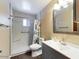 Bathroom with a gray vanity, marble tile surround shower, and updated fixtures at 5414 E Albany St, Mesa, AZ 85205