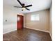 Bedroom featuring laminated wood floors, ceiling fan, light-colored walls, closet, and a large window at 5414 E Albany St, Mesa, AZ 85205