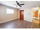 Bedroom with laminated wood floors, light-colored walls, closet and a large window at 5414 E Albany St, Mesa, AZ 85205