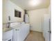 Functional laundry area featuring a washer, dryer, water heater and utility sink at 5414 E Albany St, Mesa, AZ 85205
