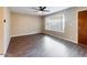 Bright living room featuring laminated wood floors, ceiling fan, light-colored walls and a large window at 5414 E Albany St, Mesa, AZ 85205