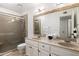 Bathroom featuring a double vanity, framed mirror and glass enclosed shower at 6043 E Hearn Rd, Scottsdale, AZ 85254