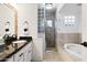 Bathroom featuring a separate shower, soaking tub, dual sinks, and a well lit mirror at 6043 E Hearn Rd, Scottsdale, AZ 85254