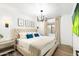 Bright bedroom featuring neutral walls, plush bedding, and stylish light fixtures at 6043 E Hearn Rd, Scottsdale, AZ 85254