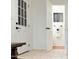 Bright hallway with tiled floors, white doors, and bench seating at 6043 E Hearn Rd, Scottsdale, AZ 85254