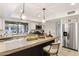 A kitchen with stainless steel appliances, ample counter space, and a breakfast bar with seating at 6043 E Hearn Rd, Scottsdale, AZ 85254