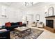 Bright living room featuring a fireplace, large rug, modern furniture, and charming décor at 6043 E Hearn Rd, Scottsdale, AZ 85254