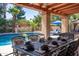 Elegant outdoor dining area with views of the pool and lush backyard at 6043 E Hearn Rd, Scottsdale, AZ 85254