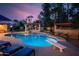 Sparkling pool and spa area surrounded by palm trees at twilight at 6043 E Hearn Rd, Scottsdale, AZ 85254