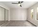 Bedroom with carpet flooring, neutral paint, sliding glass door closet, and a window at 619 E Jensen St # 14, Mesa, AZ 85203