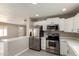 Bright kitchen featuring stainless steel appliances, white cabinets, and light countertops at 619 E Jensen St # 14, Mesa, AZ 85203