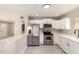Bright kitchen featuring stainless steel appliances, white cabinets, and light countertops at 619 E Jensen St # 14, Mesa, AZ 85203