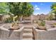 Desert landscaped backyard with fire pit area and seating at 6352 W Hackamore Dr, Phoenix, AZ 85083