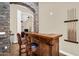 Stylish bar area with seating and rustic stone archway, perfect for entertaining guests at 6352 W Hackamore Dr, Phoenix, AZ 85083