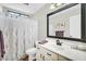Bathroom with white vanity, toilet, shower with curtain, and large mirror at 6352 W Hackamore Dr, Phoenix, AZ 85083