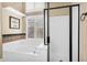 Bathroom featuring separate bathtub and shower; neutral colors and plantation shutters at 6352 W Hackamore Dr, Phoenix, AZ 85083