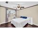 Comfortable bedroom with hardwood floors, plantation shutters, and a ceiling fan at 6352 W Hackamore Dr, Phoenix, AZ 85083