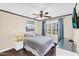 Comfortable bedroom with hardwood floors, plantation shutters, ceiling fan, and neutral decor at 6352 W Hackamore Dr, Phoenix, AZ 85083