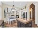 Open dining area with a chandelier, island, and view to the living room beyond the beams at 6352 W Hackamore Dr, Phoenix, AZ 85083