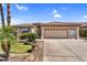 Charming single-story home with a well-manicured lawn, mature palm trees, and a spacious two-car garage at 6352 W Hackamore Dr, Phoenix, AZ 85083