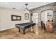 Large bonus room with stone archways and a pool table that makes for a great entertaining space at 6352 W Hackamore Dr, Phoenix, AZ 85083