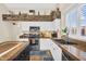 Well-lit kitchen features modern appliances, sleek white cabinetry, and decorative stone accents above cabinets at 6352 W Hackamore Dr, Phoenix, AZ 85083