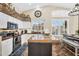 Bright open kitchen with white cabinetry, granite countertops, and stainless steel appliances at 6352 W Hackamore Dr, Phoenix, AZ 85083
