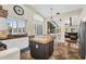 Bright open kitchen with white cabinetry, granite countertops, and stainless steel appliances overlooking the living area at 6352 W Hackamore Dr, Phoenix, AZ 85083