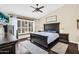 Comfortable bedroom suite with beamed accents, plantation shutters, dark wood floors and cozy decor at 6352 W Hackamore Dr, Phoenix, AZ 85083