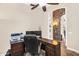 Home office features a wooden desk, and a stone archway view into another room at 6352 W Hackamore Dr, Phoenix, AZ 85083