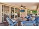 A covered patio with comfortable seating, a ceiling fan, and a TV for ultimate outdoor relaxation at 6352 W Hackamore Dr, Phoenix, AZ 85083