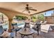 Covered patio area with comfortable seating overlooking the backyard swimming pool at 6352 W Hackamore Dr, Phoenix, AZ 85083