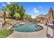 Backyard with a private pool, rock waterfall, lush landscaping, and lounge chairs at 6352 W Hackamore Dr, Phoenix, AZ 85083