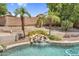 Sparkling swimming pool with waterfall feature surrounded by lush tropical landscaping at 6352 W Hackamore Dr, Phoenix, AZ 85083