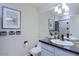 Well-lit bathroom features a double vanity with black countertops, updated fixtures, and decorative accents at 6611 N 79Th Pl, Scottsdale, AZ 85250
