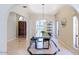 Open dining area with views into kitchen, featuring contemporary lighting and tiled flooring at 6611 N 79Th Pl, Scottsdale, AZ 85250