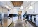 Updated kitchen with stainless steel appliances and sleek black countertops, open to dining area at 6611 N 79Th Pl, Scottsdale, AZ 85250