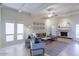 Bright living room with a large sofa, modern furniture, fireplace, and neutral color palette at 6611 N 79Th Pl, Scottsdale, AZ 85250
