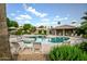 Resort-style pool area with lounge chairs and tropical landscaping, perfect for relaxation and recreation at 6611 N 79Th Pl, Scottsdale, AZ 85250