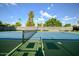 Well-maintained tennis court surrounded by mature trees, ideal for recreational play and exercise at 6611 N 79Th Pl, Scottsdale, AZ 85250