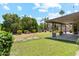 Landscaped backyard oasis with lush greenery, patio, shed, and blue sky at 6717 E Aire Libre Ln, Scottsdale, AZ 85254