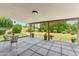 Inviting covered back patio featuring tiled flooring, a dining set, and a serene backyard view at 6717 E Aire Libre Ln, Scottsdale, AZ 85254