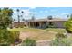 Expansive backyard with a covered patio, lush greenery, and well-maintained landscaping at 6717 E Aire Libre Ln, Scottsdale, AZ 85254