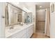 Bathroom features a double sink vanity, a large mirror, and a glass-enclosed shower stall with tiled walls at 6717 E Aire Libre Ln, Scottsdale, AZ 85254