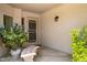 Cozy entryway with a decorative bench, unique wrought iron door, and lush plants at 6717 E Aire Libre Ln, Scottsdale, AZ 85254