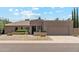 Charming single-story home featuring a two-car garage, gravel landscaping, and stylish architectural details at 6717 E Aire Libre Ln, Scottsdale, AZ 85254